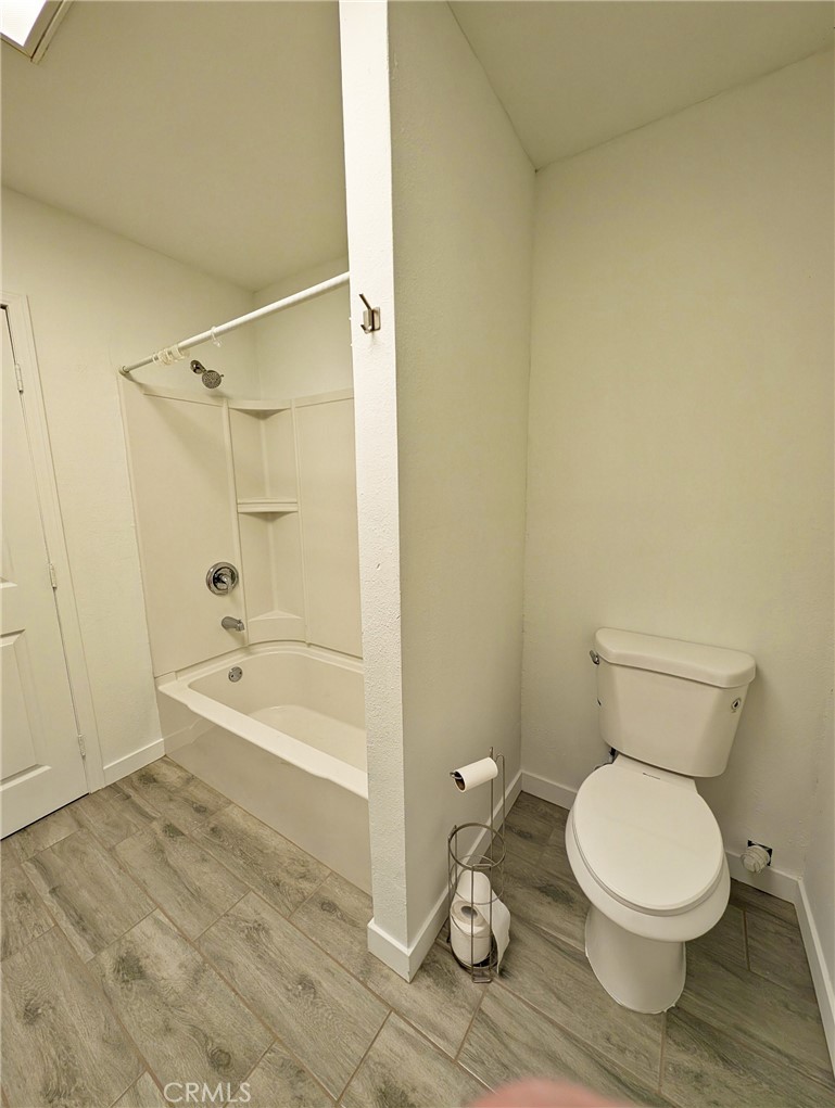379 North 3rd Street Grover Beach, CA 93433 - Photo 13 of 24 a white toilet sitting next to a bath tub and a shower