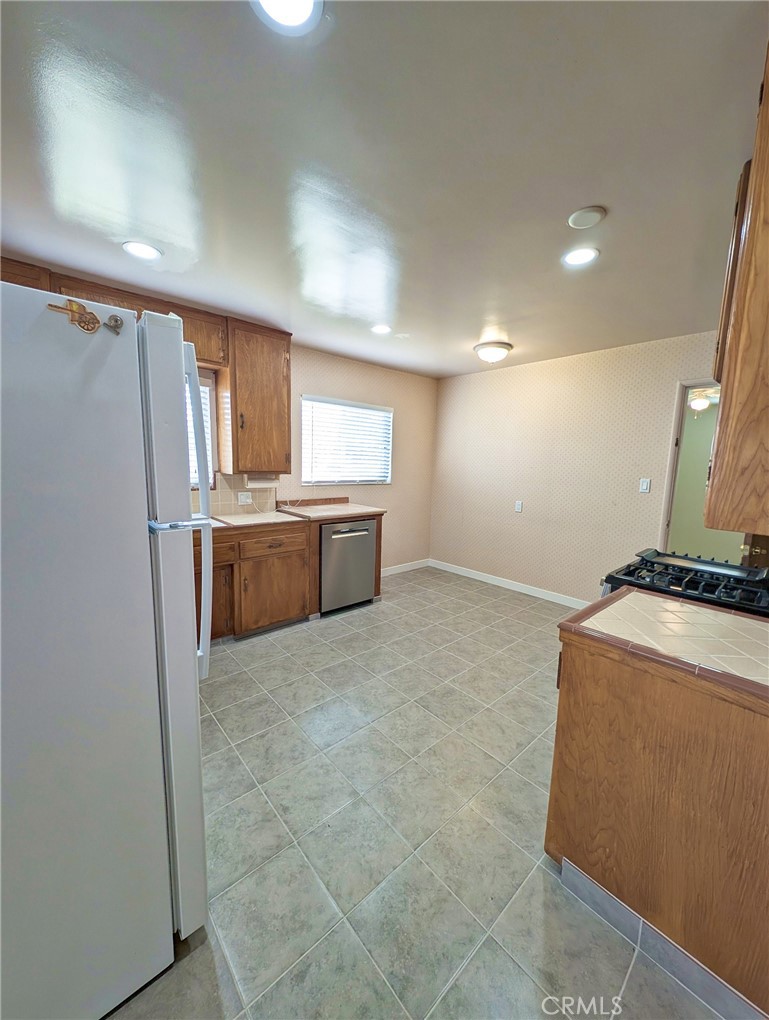 379 North 3rd Street Grover Beach, CA 93433 - Photo 5 of 24 a kitchen with refrigerator and window