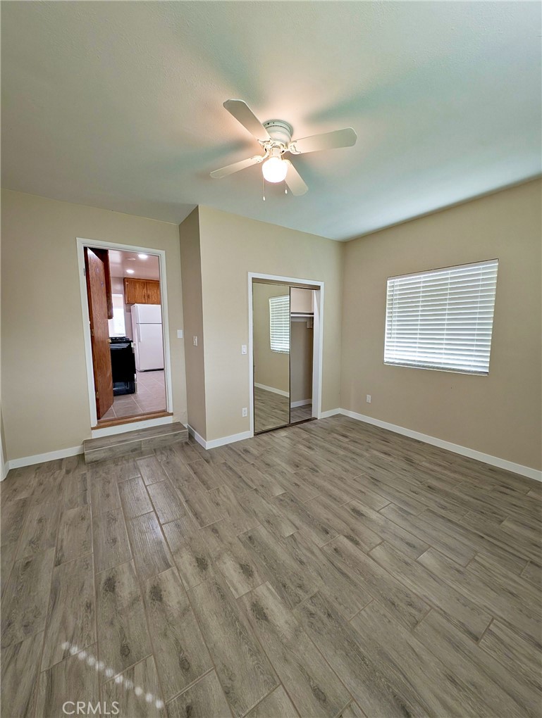 379 North 3rd Street Grover Beach, CA 93433 - Photo 9 of 24 a view of an empty room with window and wooden floor