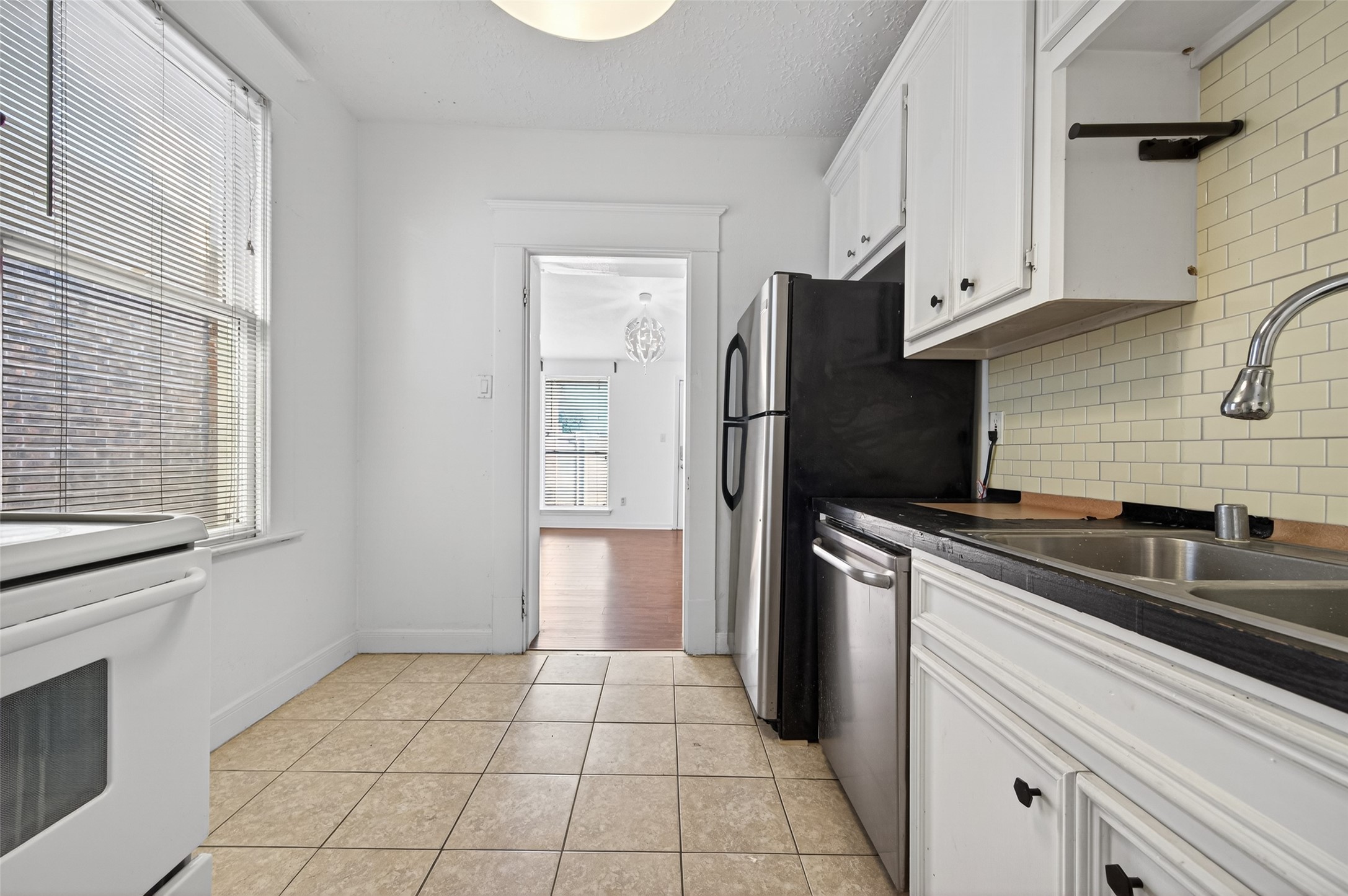 324 West Alabama Street, Unit 1 Houston, TX 77006 - Photo 18 of 30 a kitchen with a refrigerator sink and cabinets