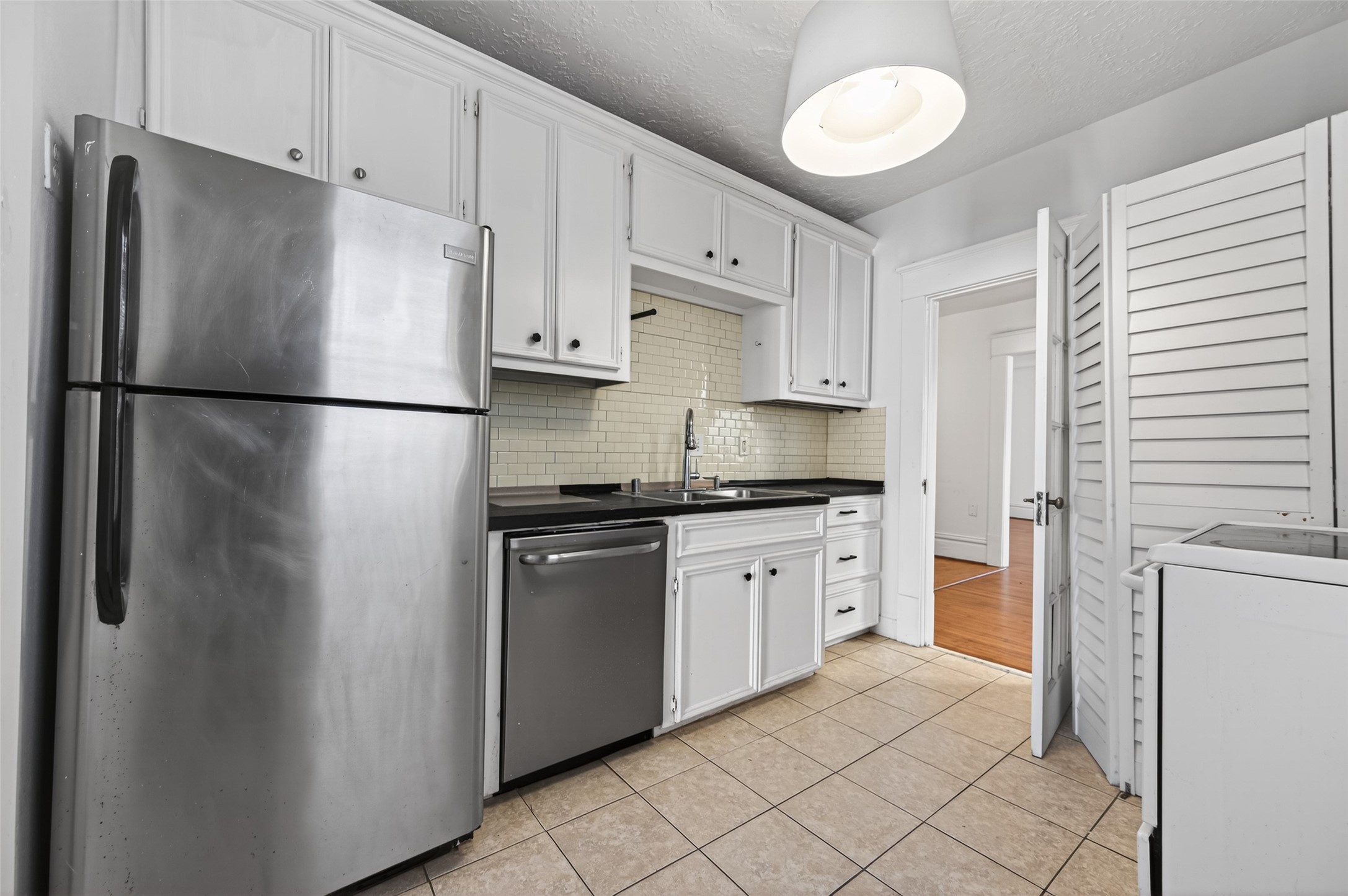324 West Alabama Street, Unit 1 Houston, TX 77006 - Photo 21 of 30 a white refrigerator freezer sitting in a kitchen