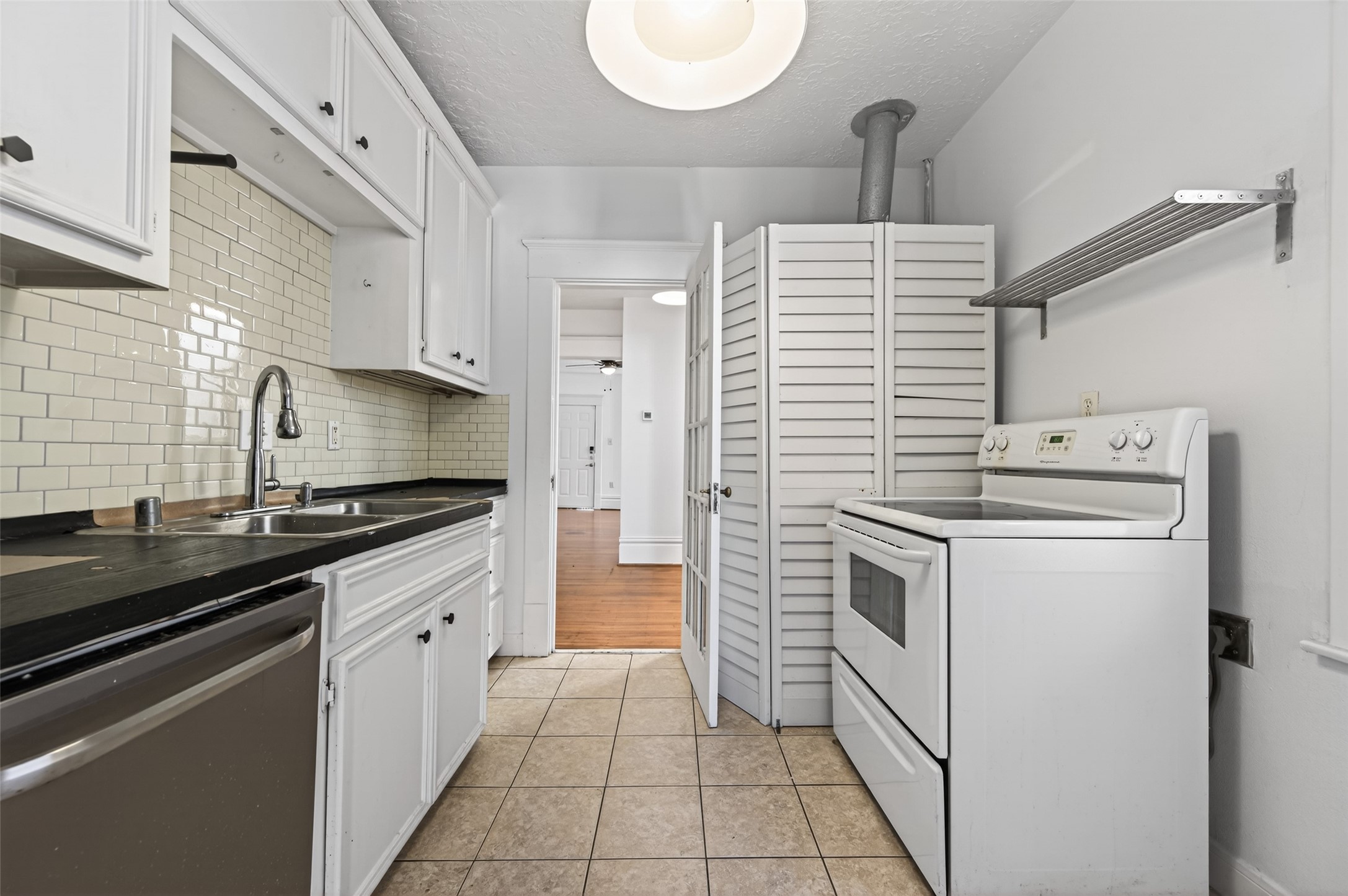 324 West Alabama Street, Unit 1 Houston, TX 77006 - Photo 22 of 30 a kitchen with a sink stove and cabinets