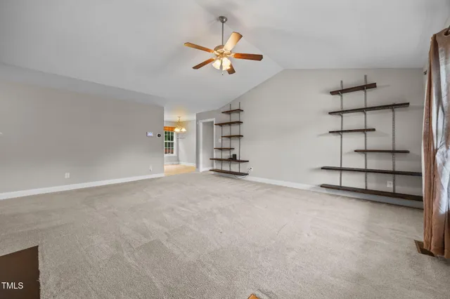 a view of an empty room with a ceiling fan