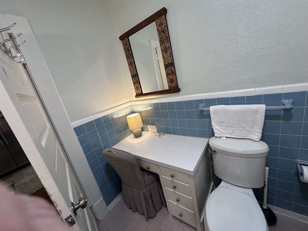 443 2nd Avenue Columbus, GA 31901 - Photo 8 of 20 a bathroom with a toilet a sink and a mirror