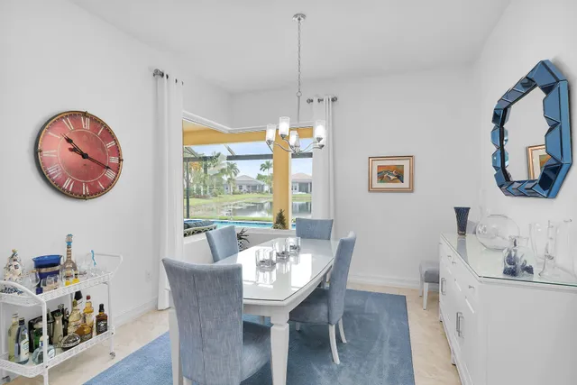 a room with wooden floor table and chairs