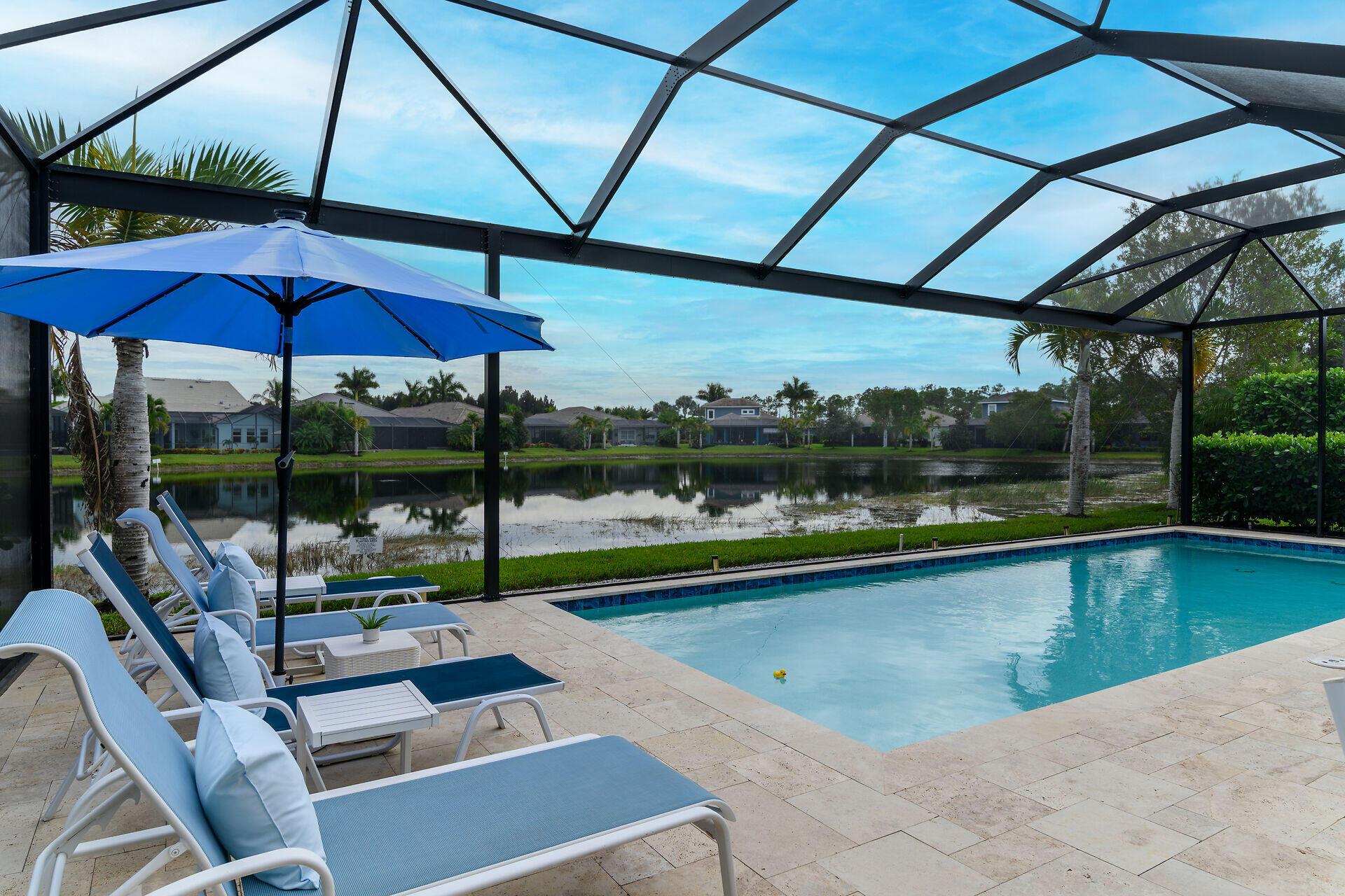 14730 Nautilus Place Naples, FL 34114 - Photo 16 of 56 a view of a swimming pool with a porch
