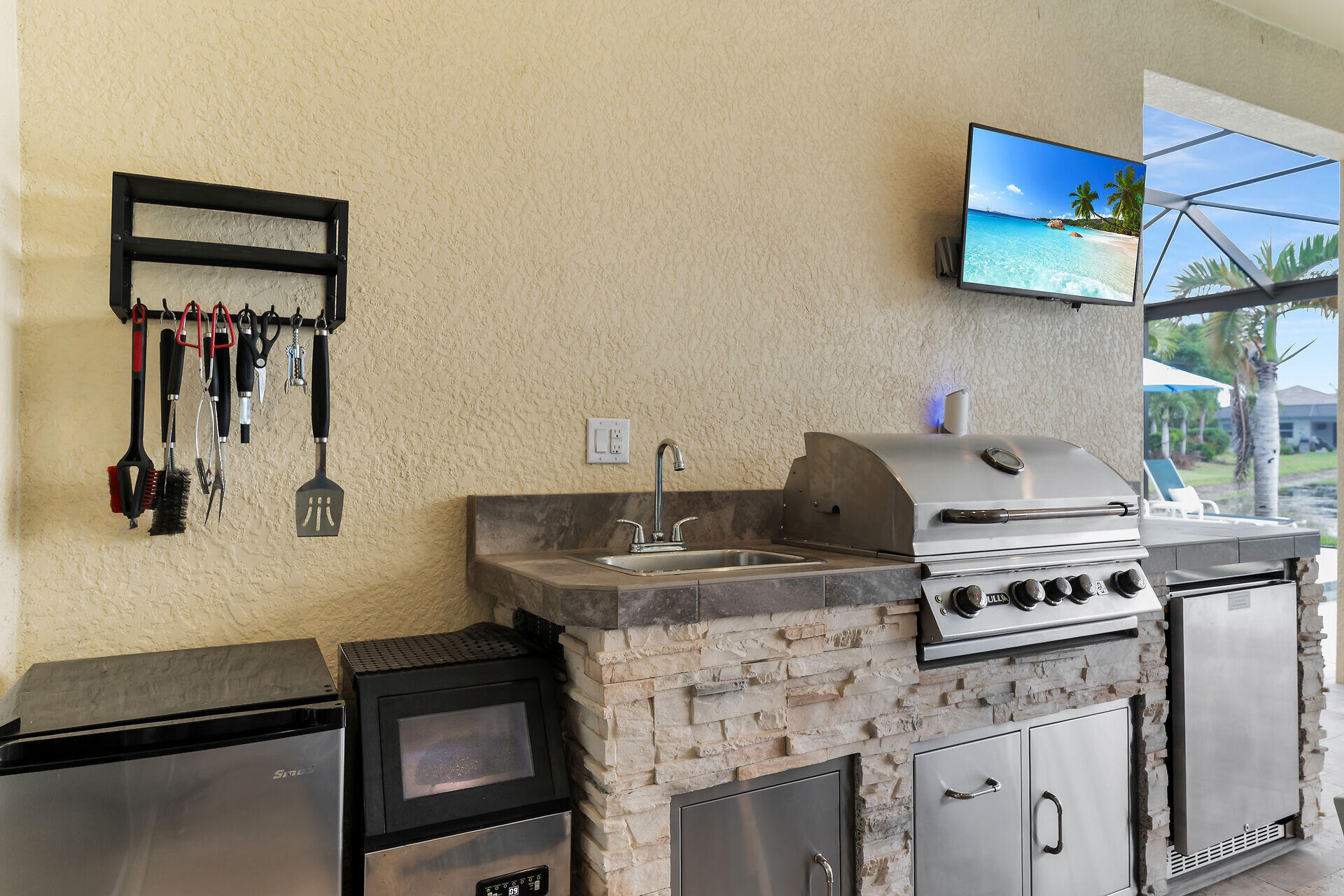 14730 Nautilus Place Naples, FL 34114 - Photo 20 of 56 a kitchen with stainless steel appliances granite countertop a stove a sink and a refrigerator