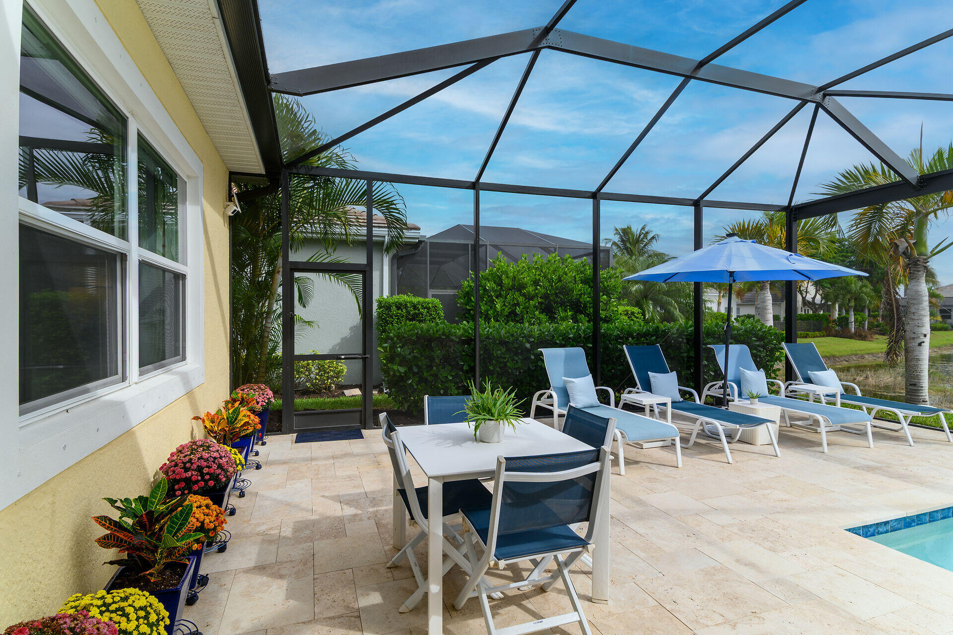 14730 Nautilus Place Naples, FL 34114 - Photo 21 of 56 a view of patio with a table and chairs under an umbrella