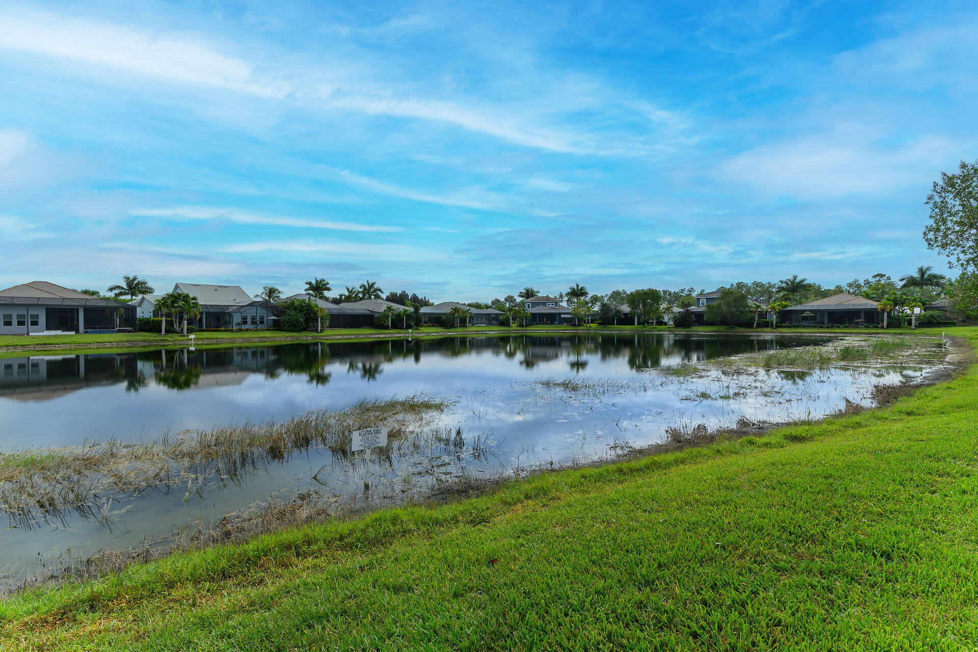 14730 Nautilus Place Naples, FL 34114 - Photo 22 of 56 a view of a lake with houses in the back