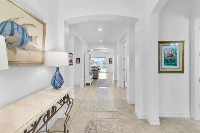 a view of a hallway and a livingroom with furniture