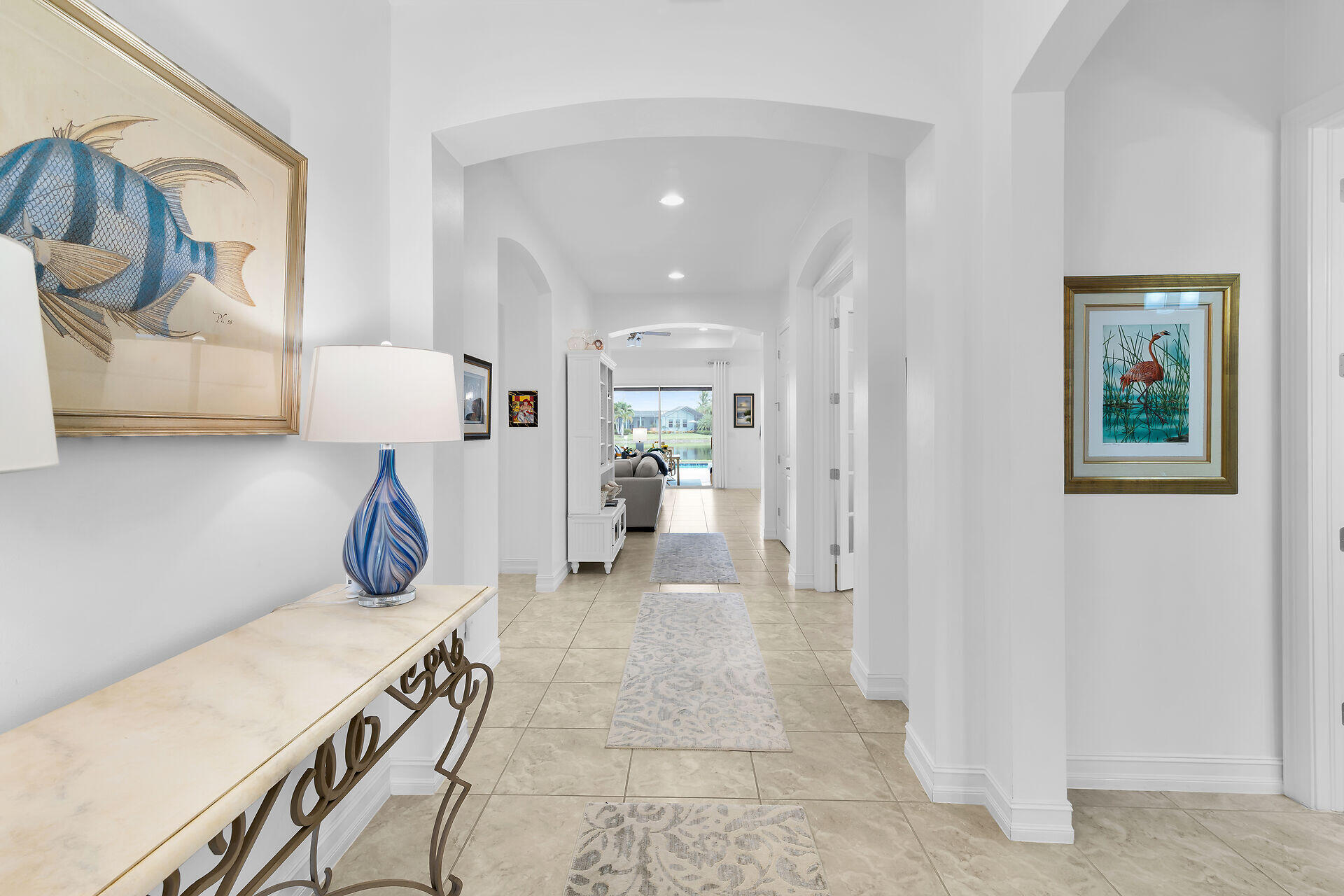 14730 Nautilus Place Naples, FL 34114 - Photo 3 of 56 a view of a hallway and a livingroom with furniture