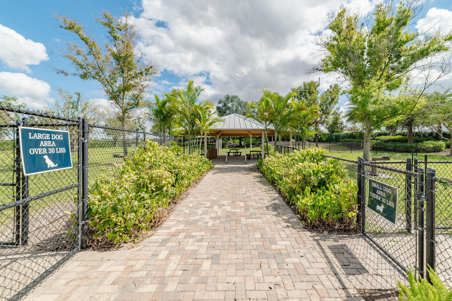 14730 Nautilus Place Naples, FL 34114 - Photo 43 of 56 a view of a pathway with a bench in front of house