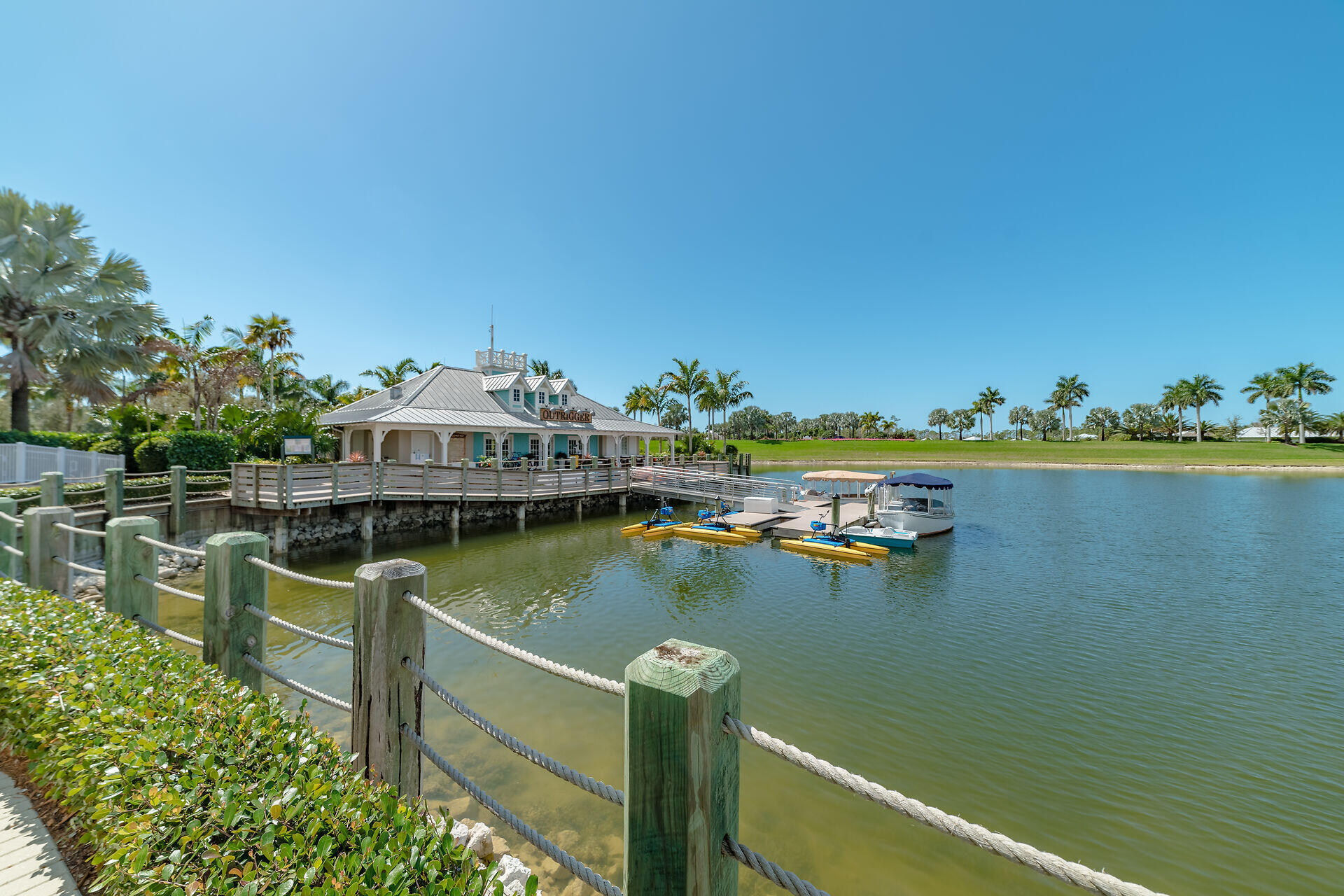 14730 Nautilus Place Naples, FL 34114 - Photo 51 of 56 a view of a lake with boats and trees in the background