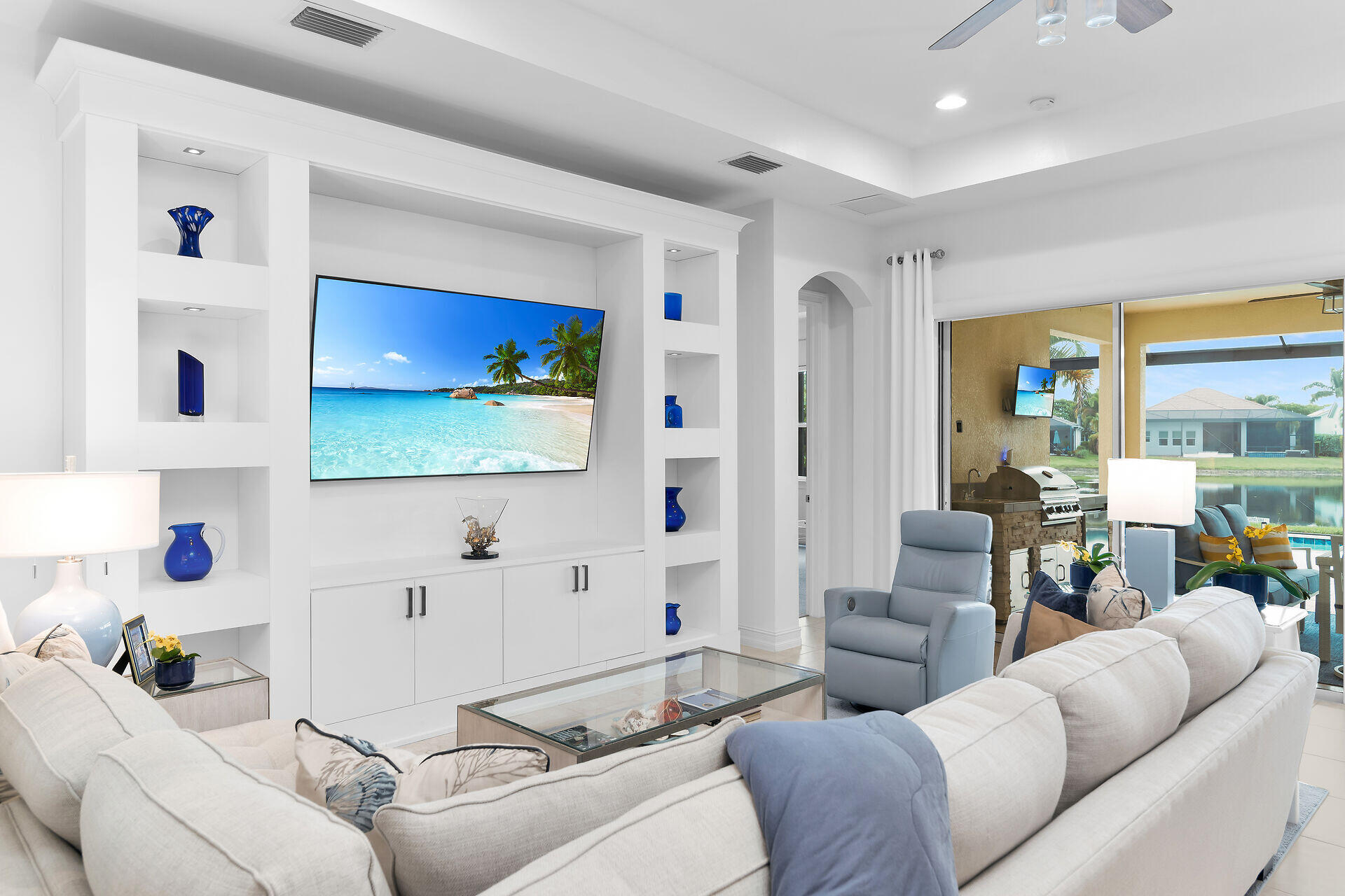 14730 Nautilus Place Naples, FL 34114 - Photo 6 of 56 a living room with furniture and a flat screen tv