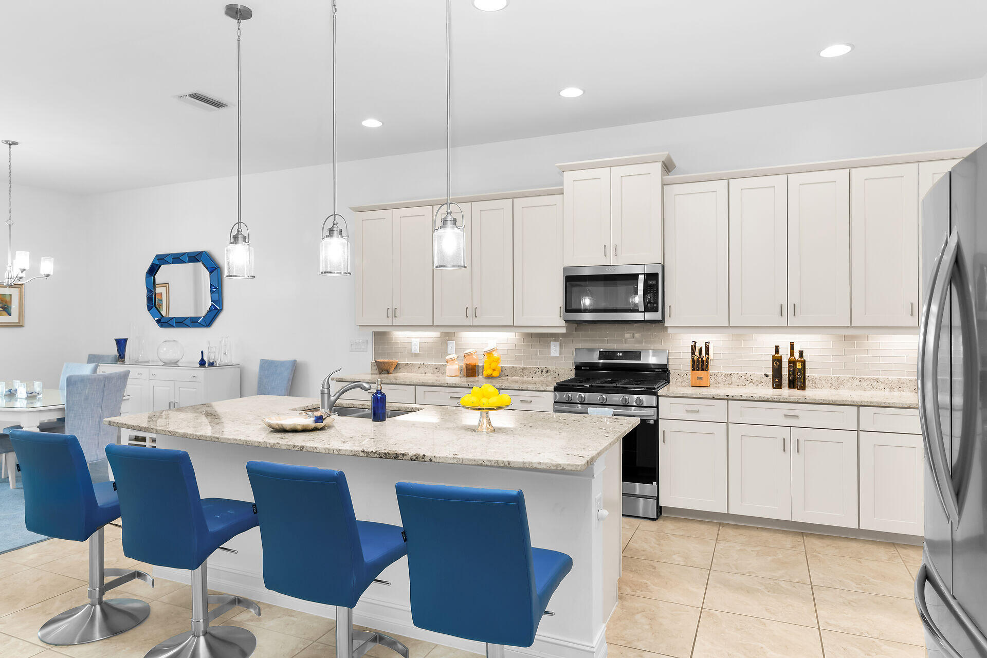 14730 Nautilus Place Naples, FL 34114 - Photo 8 of 56 a kitchen with a sink stove and microwave