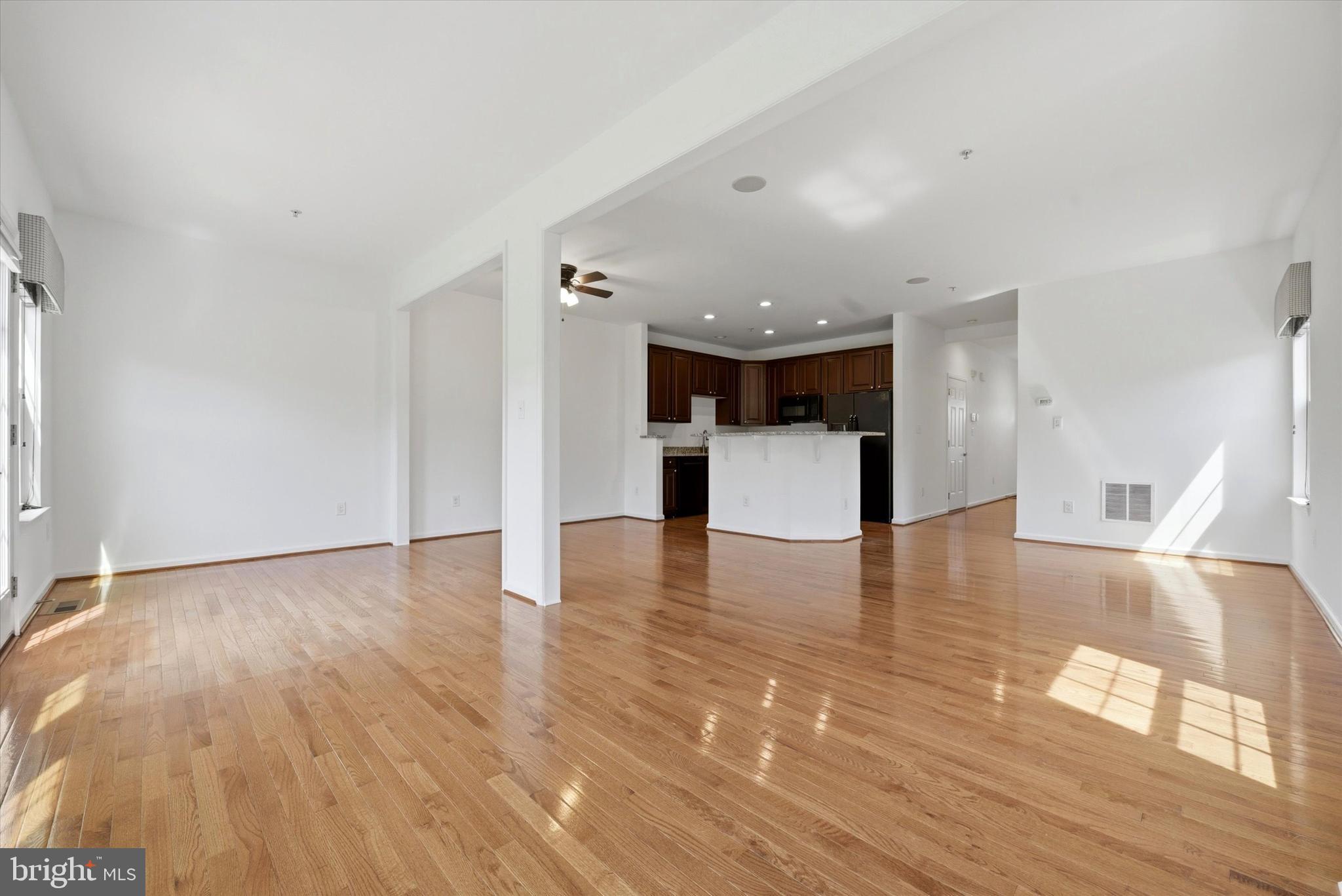 186 Tulsk Road Avondale, PA 19311 - Photo 13 of 38 a view of empty room with wooden floor and kitchen view