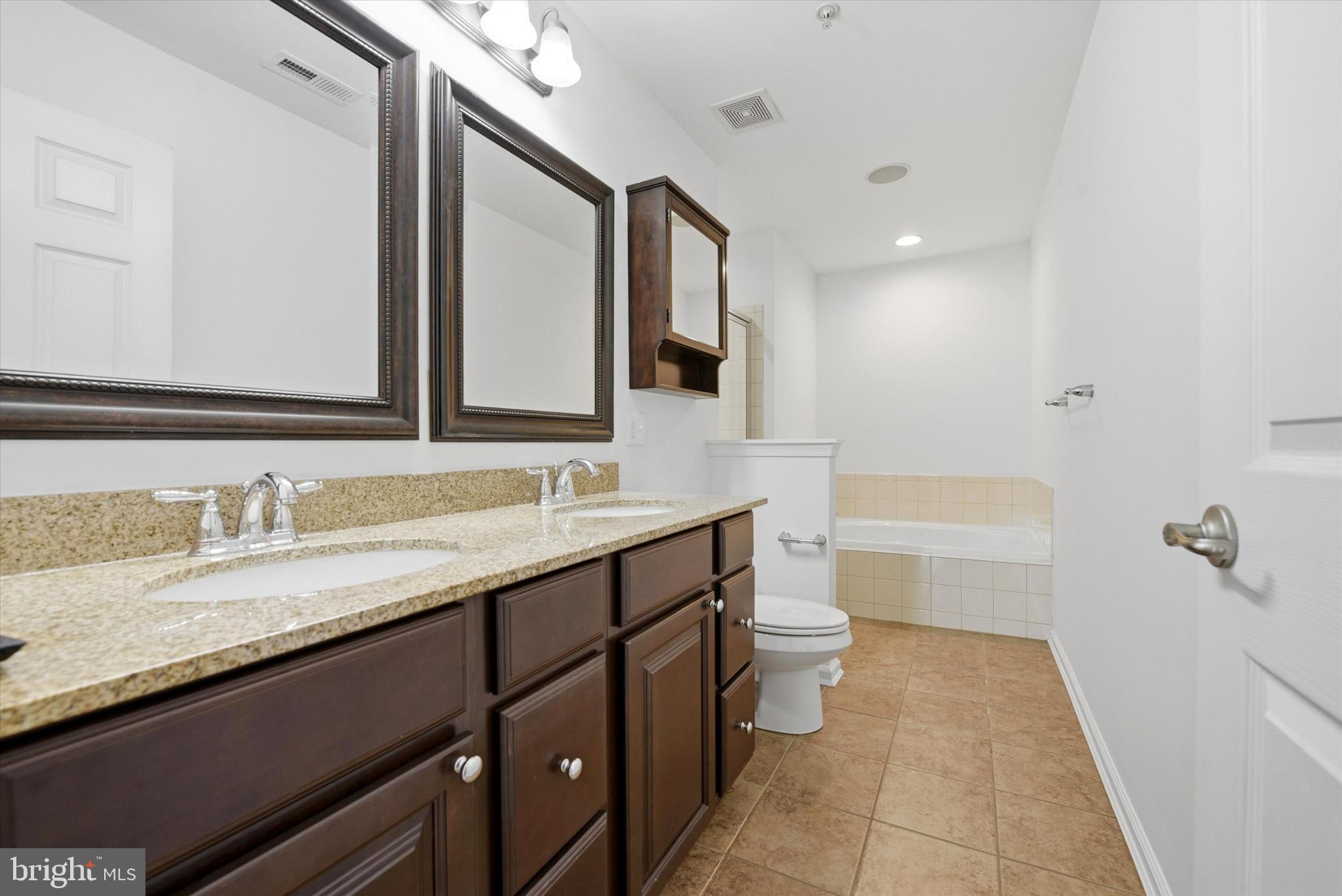 186 Tulsk Road Avondale, PA 19311 - Photo 25 of 38 a bathroom with a granite countertop sink mirror and a bathtub