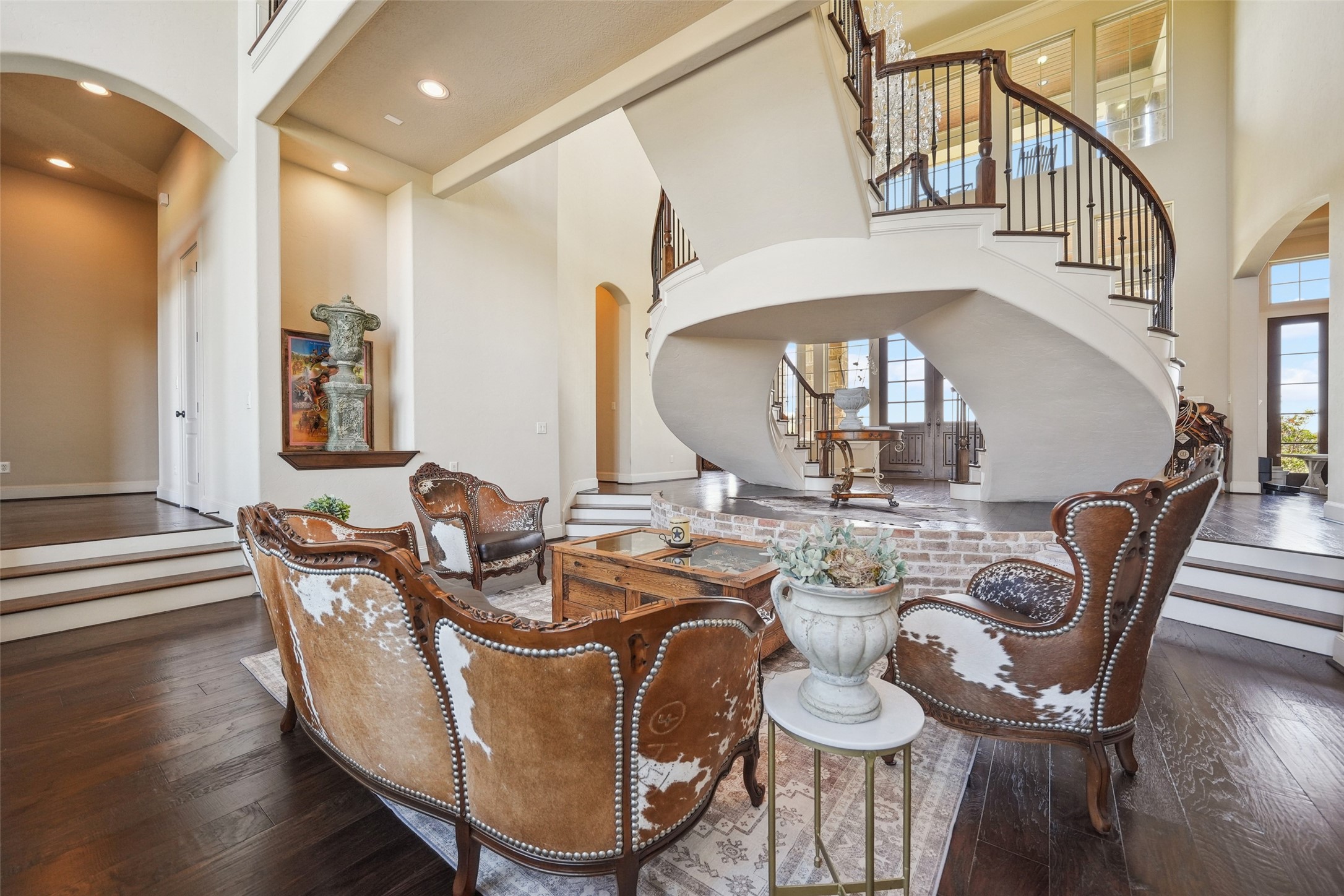 460 Bishop Road Huntsville, TX 77320 - Photo 12 of 50 Step down into a refined formal living room with expansive walls of windows, two illuminated art niches, and a breathtaking 40-foot ceiling.