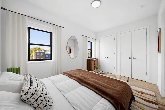 a bedroom with a bed and a mirror