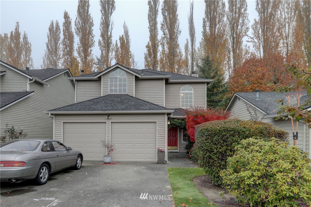 5142 South Garden Loop Road Seattle, WA 98118 - Photo 1 of 18 a car parked in front of a house