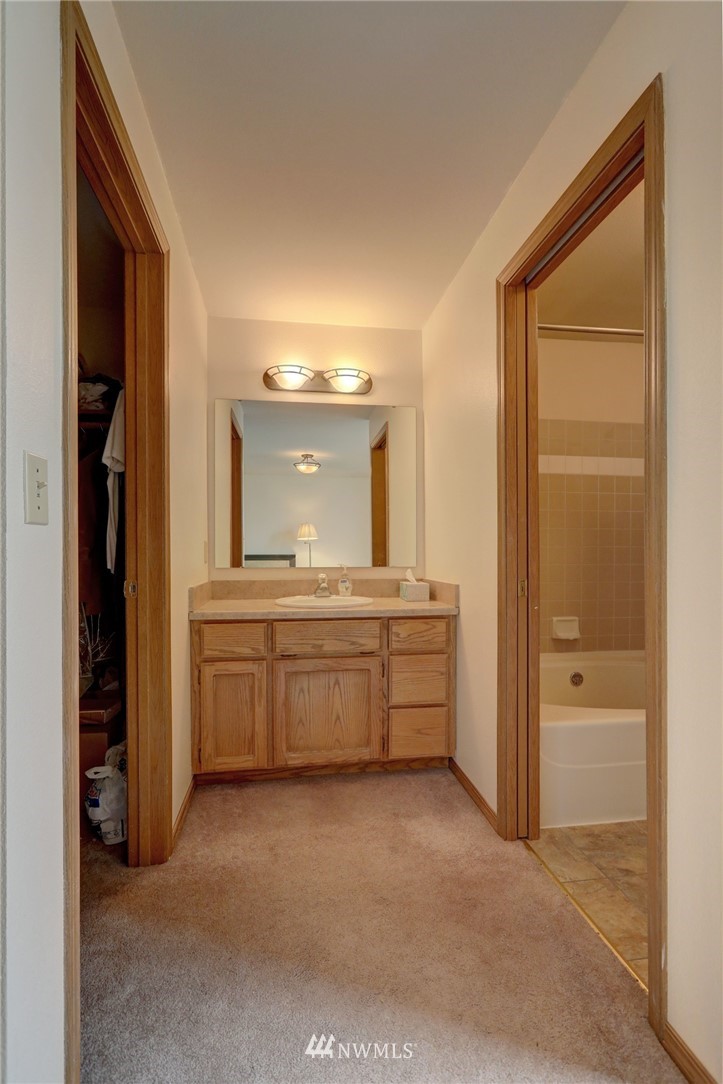5142 South Garden Loop Road Seattle, WA 98118 - Photo 11 of 18 a room with a bed and a view of mirror