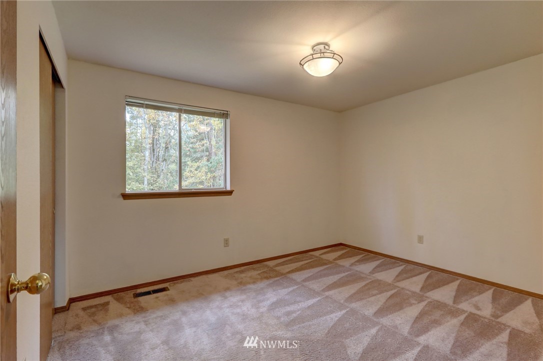 5142 South Garden Loop Road Seattle, WA 98118 - Photo 12 of 18 an empty room with a window