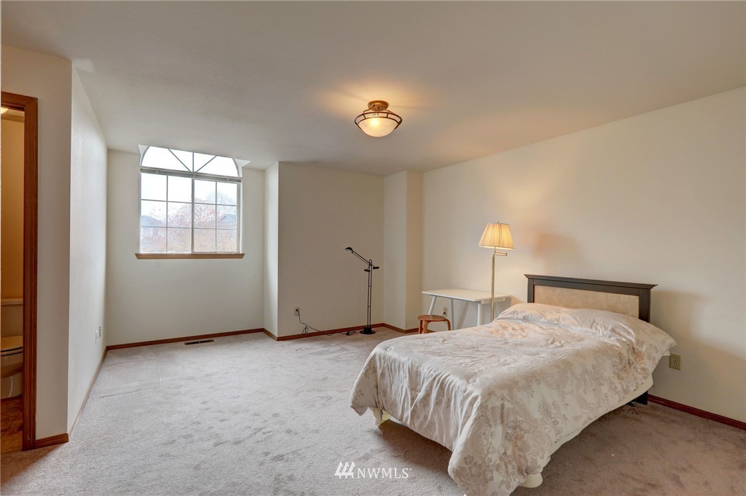 5142 South Garden Loop Road Seattle, WA 98118 - Photo 16 of 18 a bedroom with a bed and a window