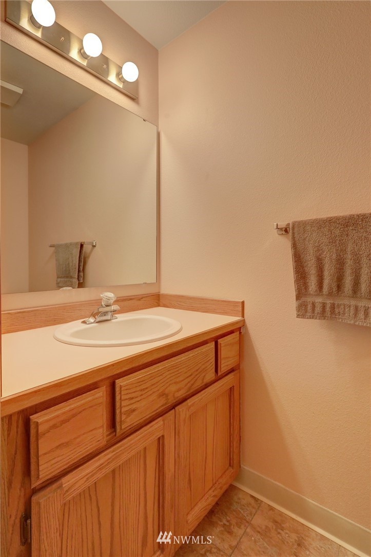 5142 South Garden Loop Road Seattle, WA 98118 - Photo 17 of 18 a bathroom with a sink and a mirror