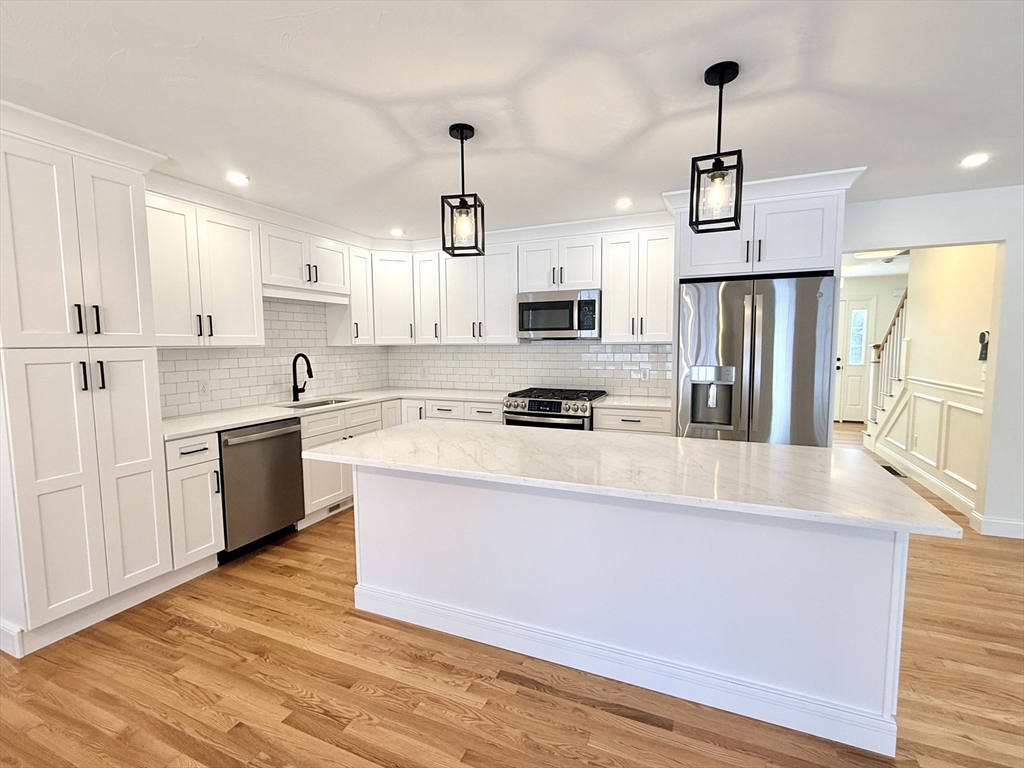 28 Forest Hill Drive Rutland, MA 01543 - Photo 2 of 23 a large kitchen with stainless steel appliances a refrigerator stove a sink and a center island