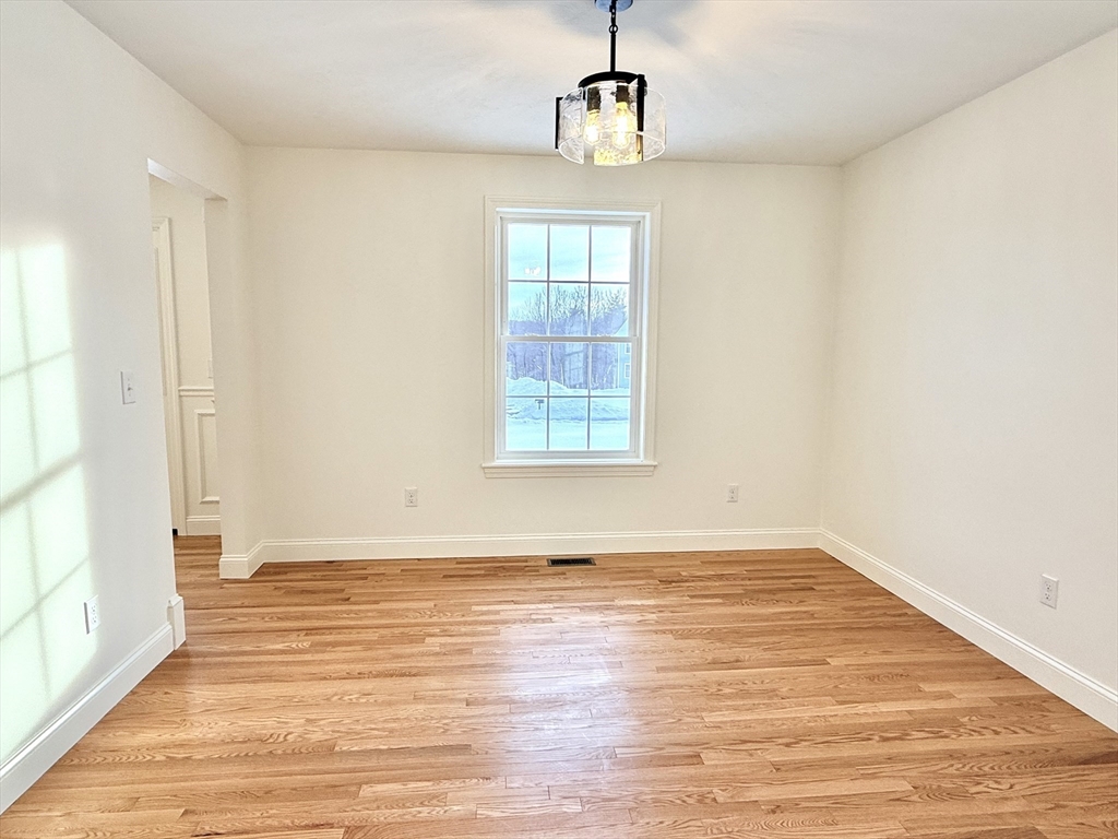 28 Forest Hill Drive Rutland, MA 01543 - Photo 10 of 23 a view of an empty room with wooden floor and a window