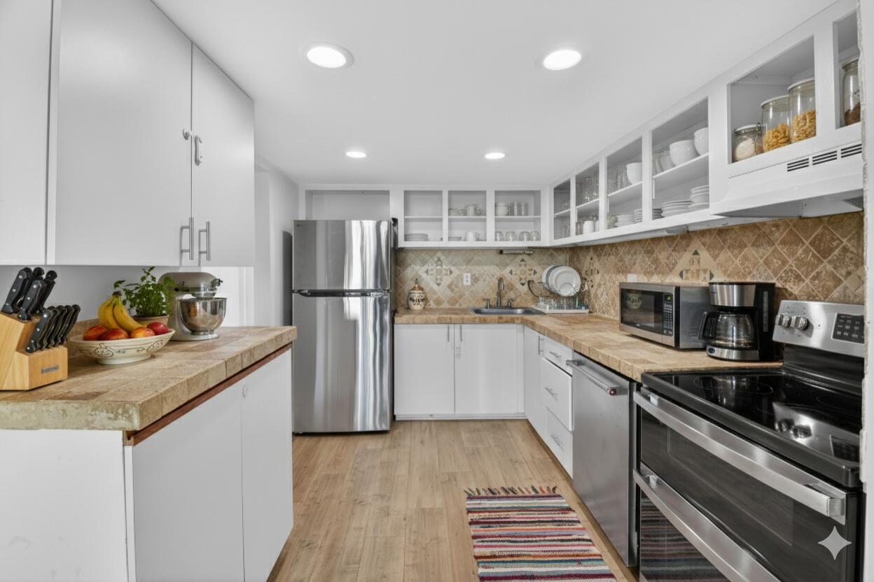 a kitchen with stainless steel appliances granite countertop a sink stove and refrigerator