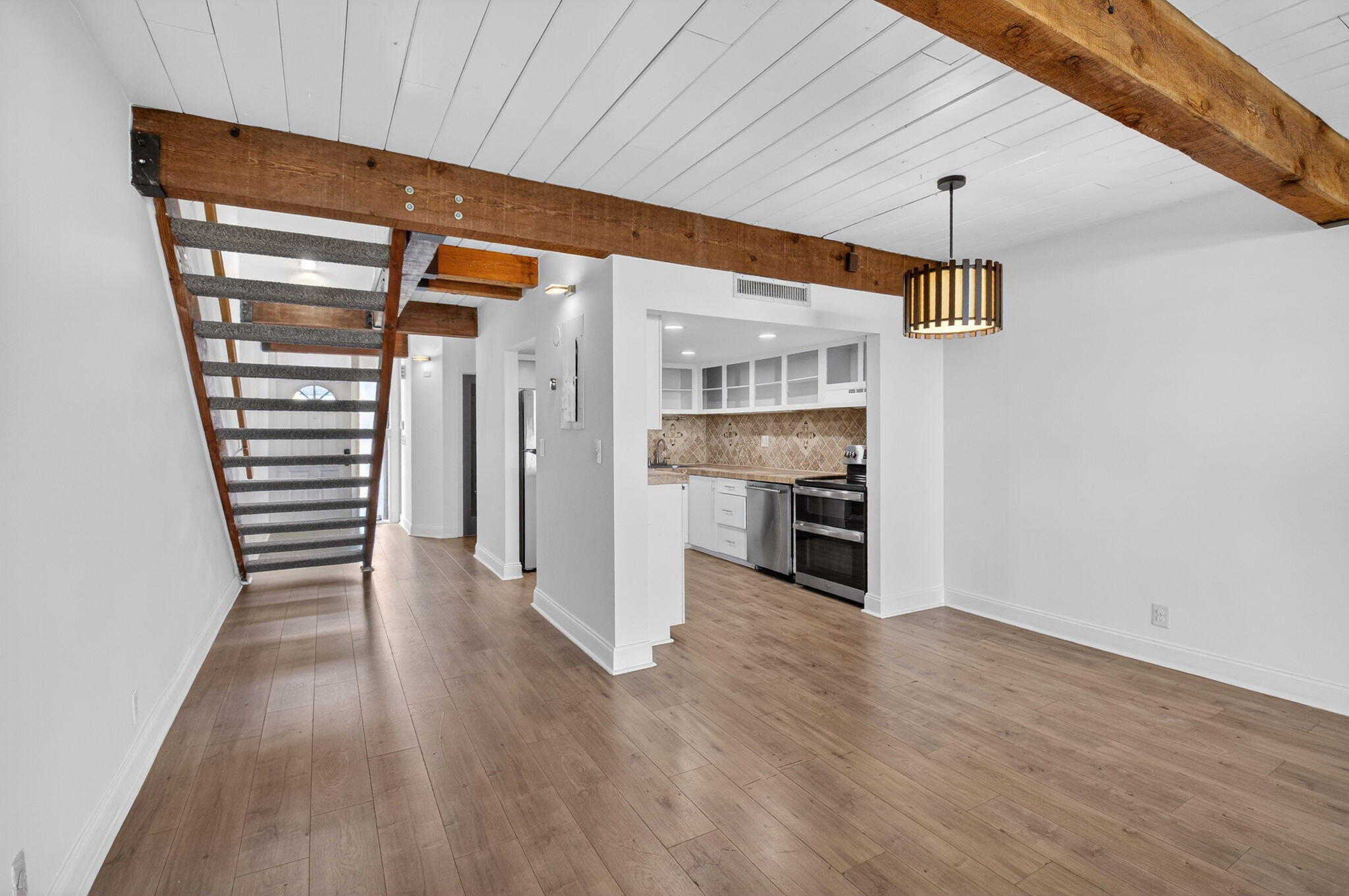 4761 Northwest 2nd Avenue, Unit 301 Boca Raton, FL 33431 - Photo 12 of 56 a view of a kitchen with wooden floor and a ceiling fan