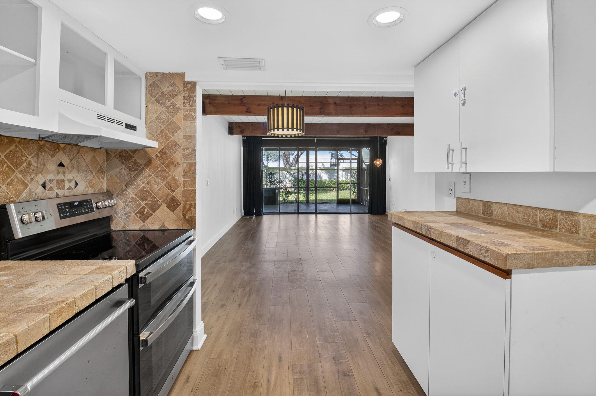 4761 Northwest 2nd Avenue, Unit 301 Boca Raton, FL 33431 - Photo 17 of 56 a kitchen with granite countertop a stove and cabinets