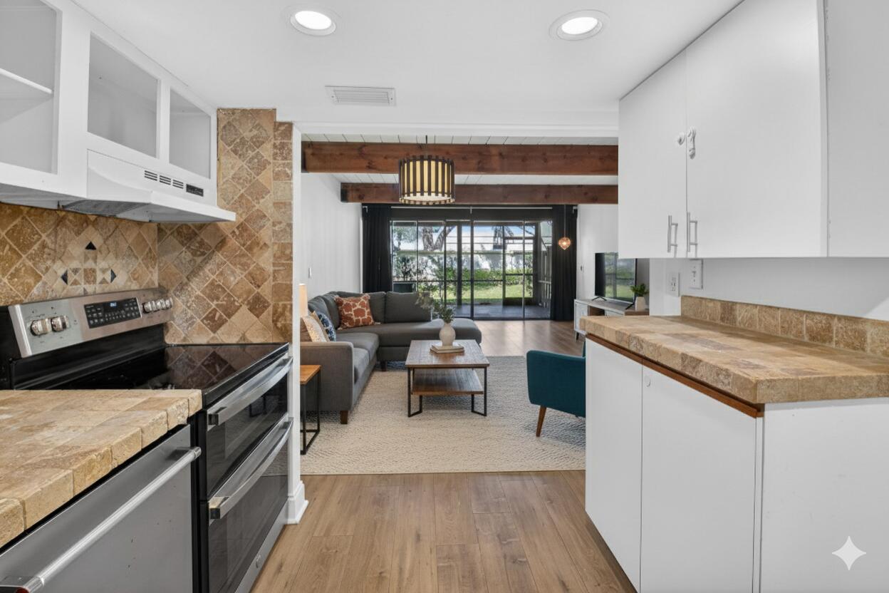 4761 Northwest 2nd Avenue, Unit 301 Boca Raton, FL 33431 - Photo 18 of 56 a kitchen with granite countertop lots of counter top space and stainless steel appliances