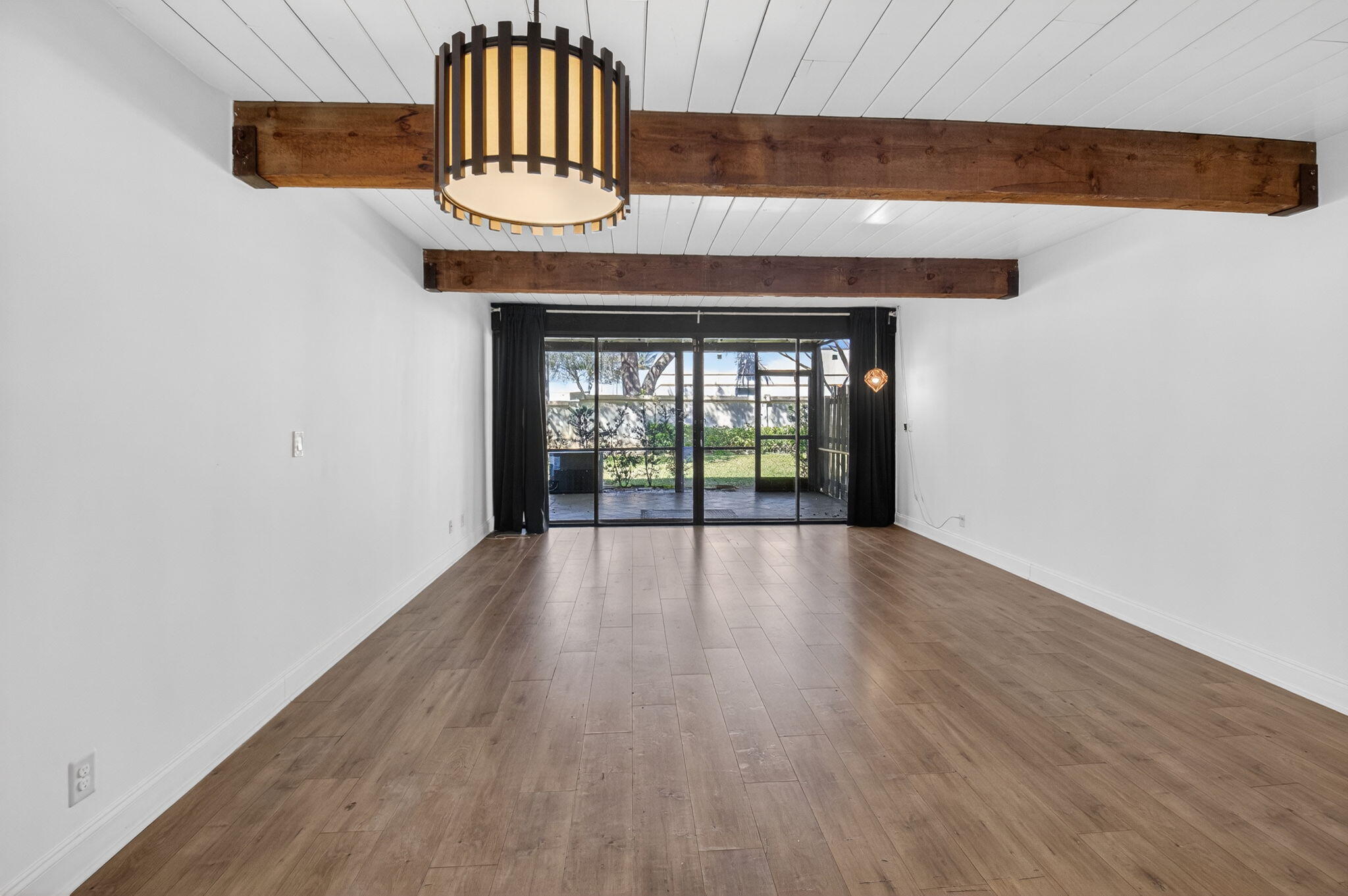 4761 Northwest 2nd Avenue, Unit 301 Boca Raton, FL 33431 - Photo 19 of 56 a view of an empty room with wooden floor and a window