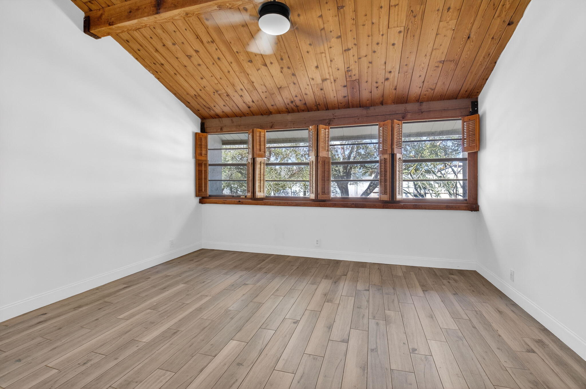 4761 Northwest 2nd Avenue, Unit 301 Boca Raton, FL 33431 - Photo 34 of 56 an empty room with wooden floor and windows
