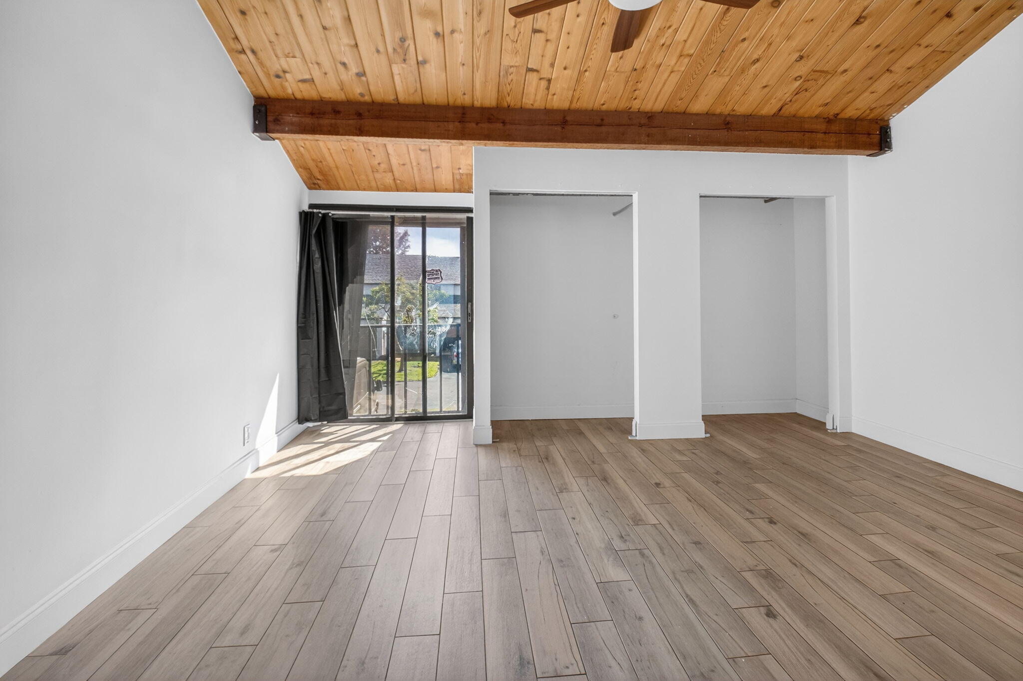 4761 Northwest 2nd Avenue, Unit 301 Boca Raton, FL 33431 - Photo 41 of 56 a view of an empty room with wooden floor and a window