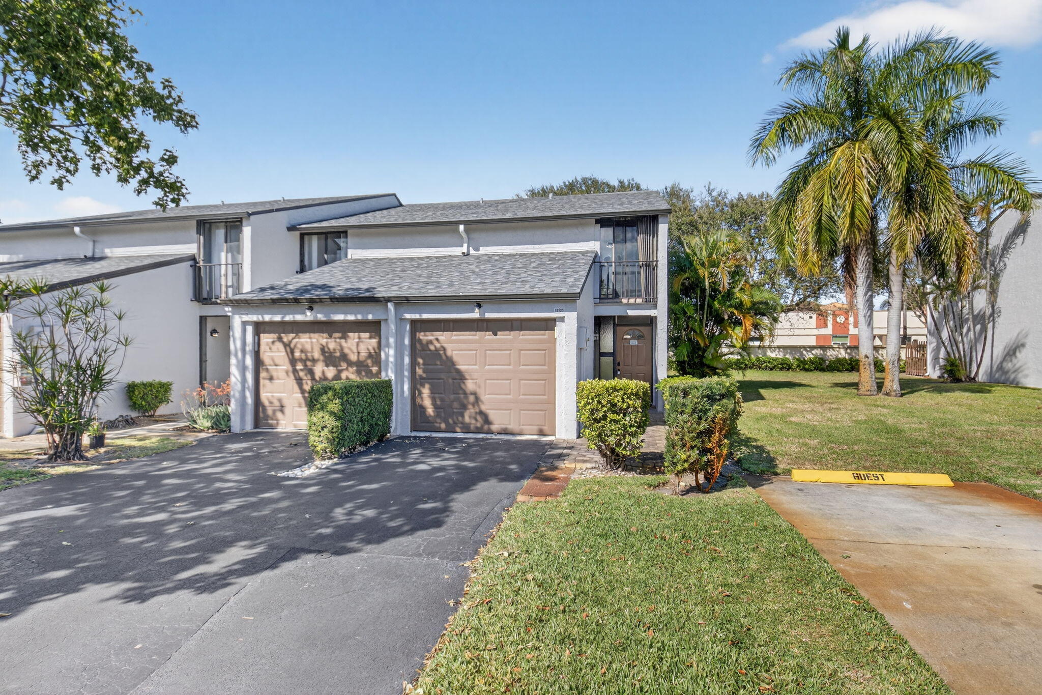 4761 Northwest 2nd Avenue, Unit 301 Boca Raton, FL 33431 - Photo 8 of 56 a front view of a house with a yard and potted plants