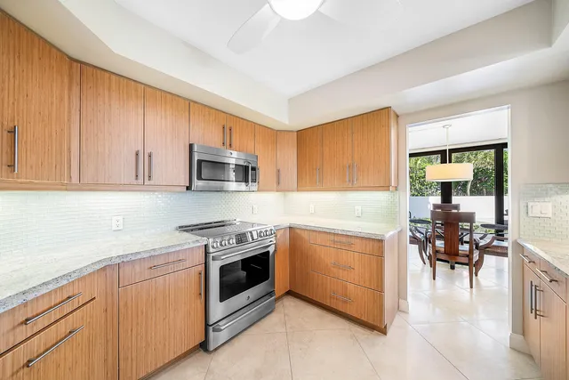 a kitchen with granite countertop cabinets stainless steel appliances and dining table