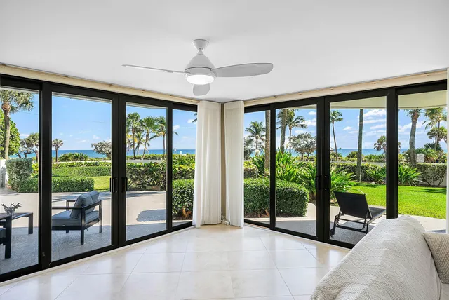 a view of a livingroom with furniture staircase and floor to ceiling window