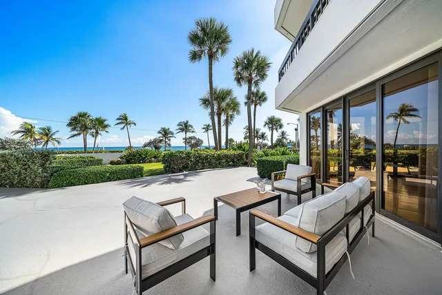 a view of swimming pool with outdoor seating and a garden