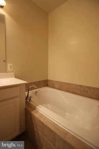 a bathroom with a bathtub and a sink