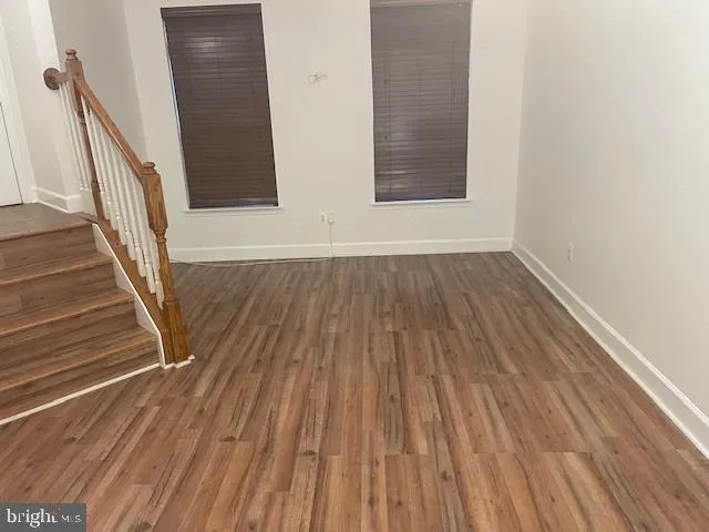 a view of a room with wooden floor and staircase