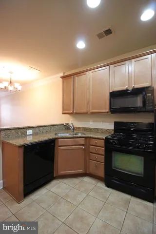 a kitchen with stainless steel appliances granite countertop a stove and a microwave