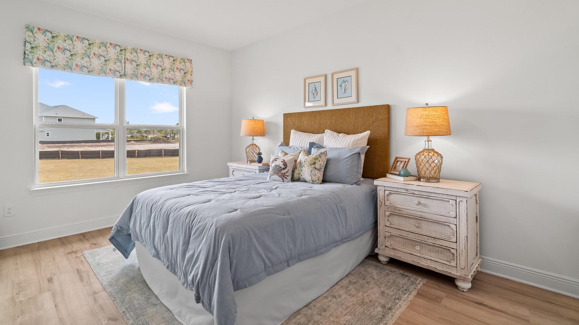 49 West Farm Owl Drive Freeport, FL 32439 - Photo 21 of 32 a bedroom with a bed and wooden floor