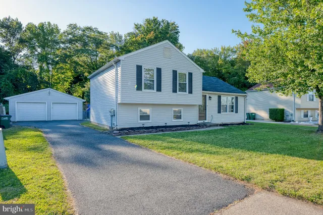 a view of a house with a yard and a garden