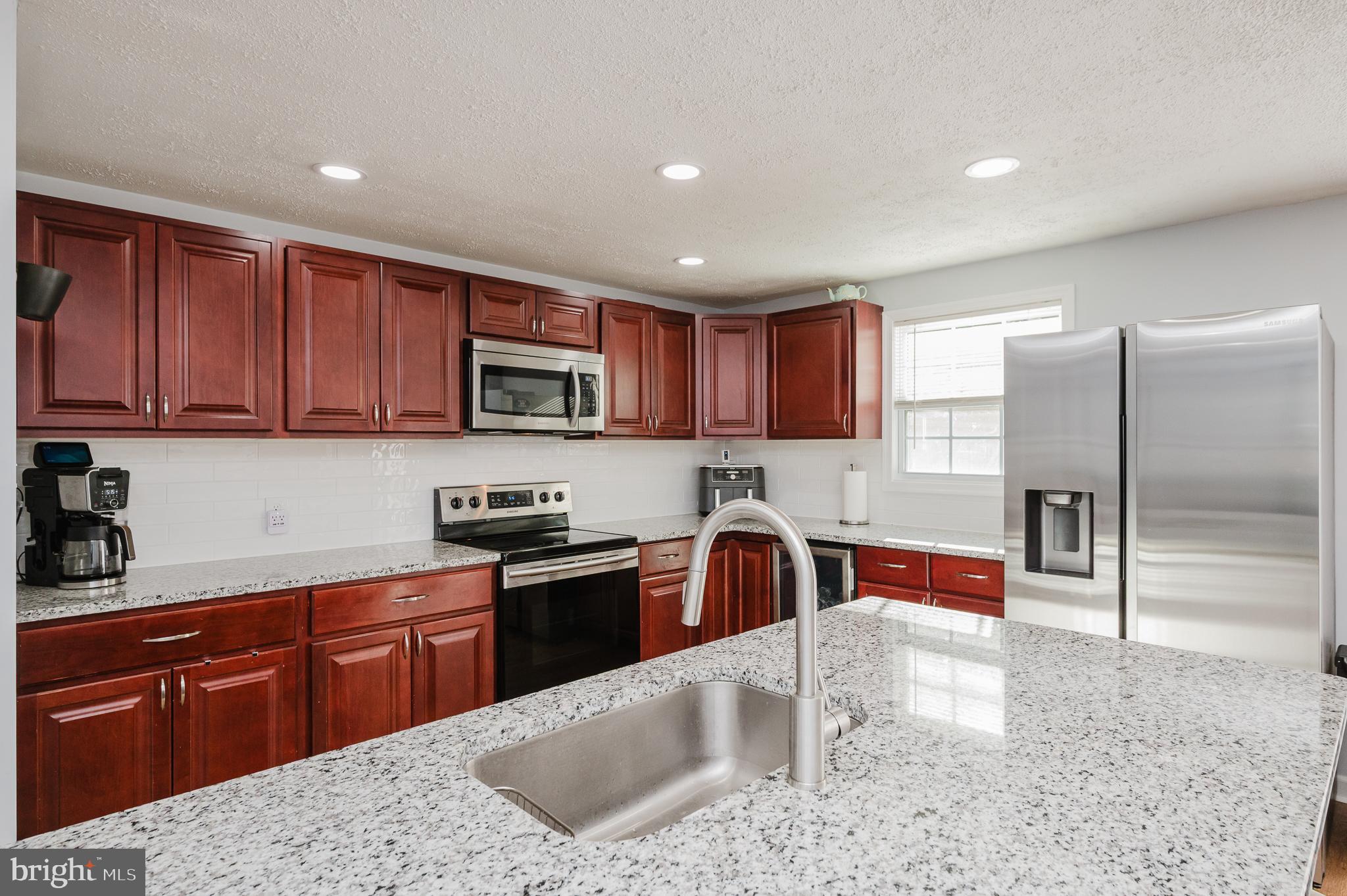 930 Edmund Street Aberdeen, MD 21001 - Photo 11 of 61 a kitchen with stainless steel appliances granite countertop a sink stove and refrigerator