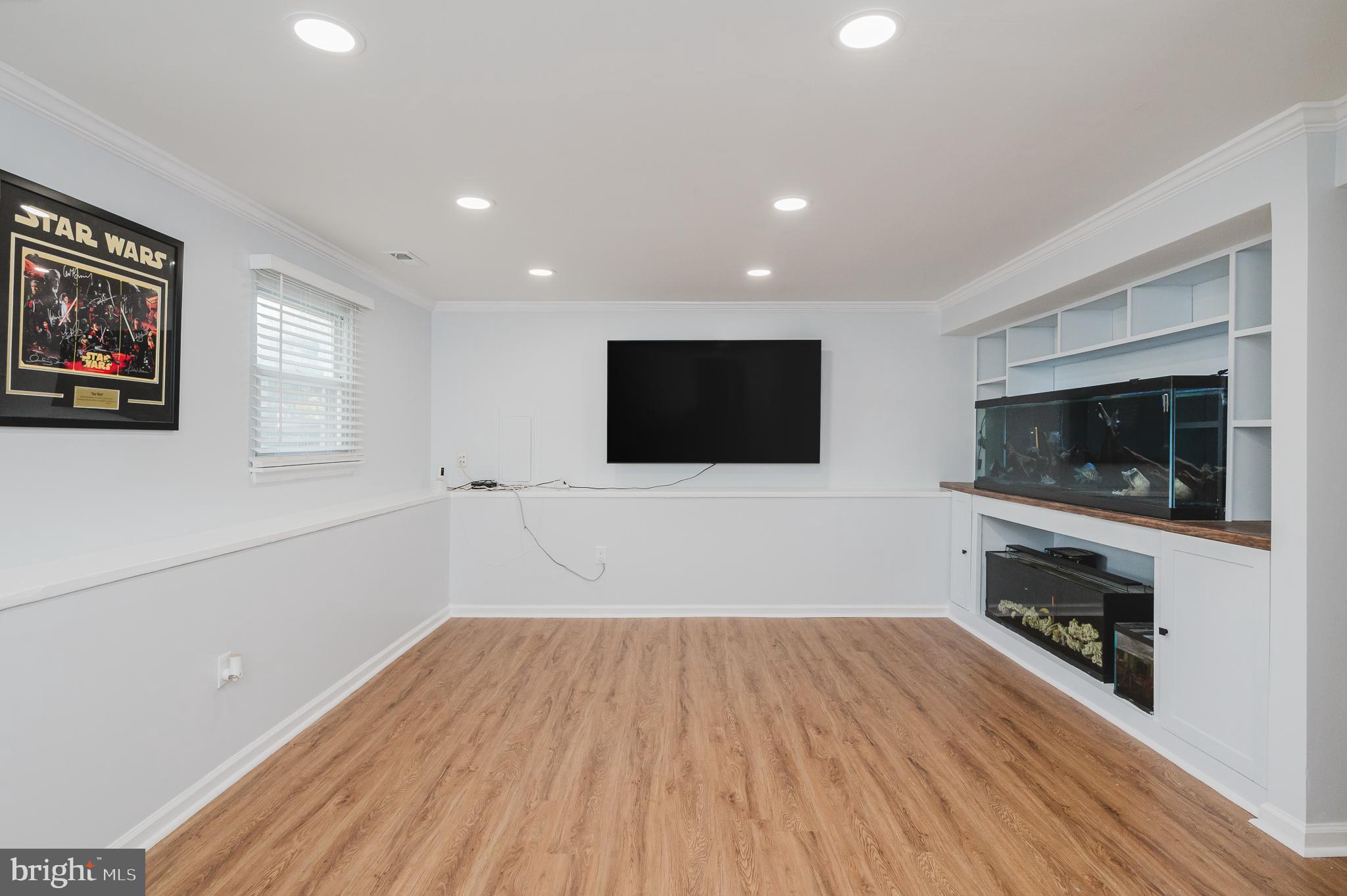 930 Edmund Street Aberdeen, MD 21001 - Photo 39 of 61 a view of a livingroom with wooden floor and a flat screen tv