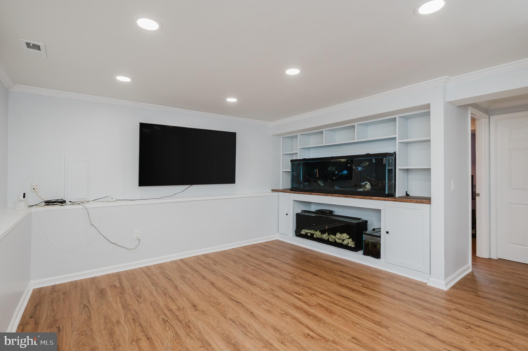 930 Edmund Street Aberdeen, MD 21001 - Photo 40 of 61 a view of a livingroom with an empty space and a kitchen with wooden floor