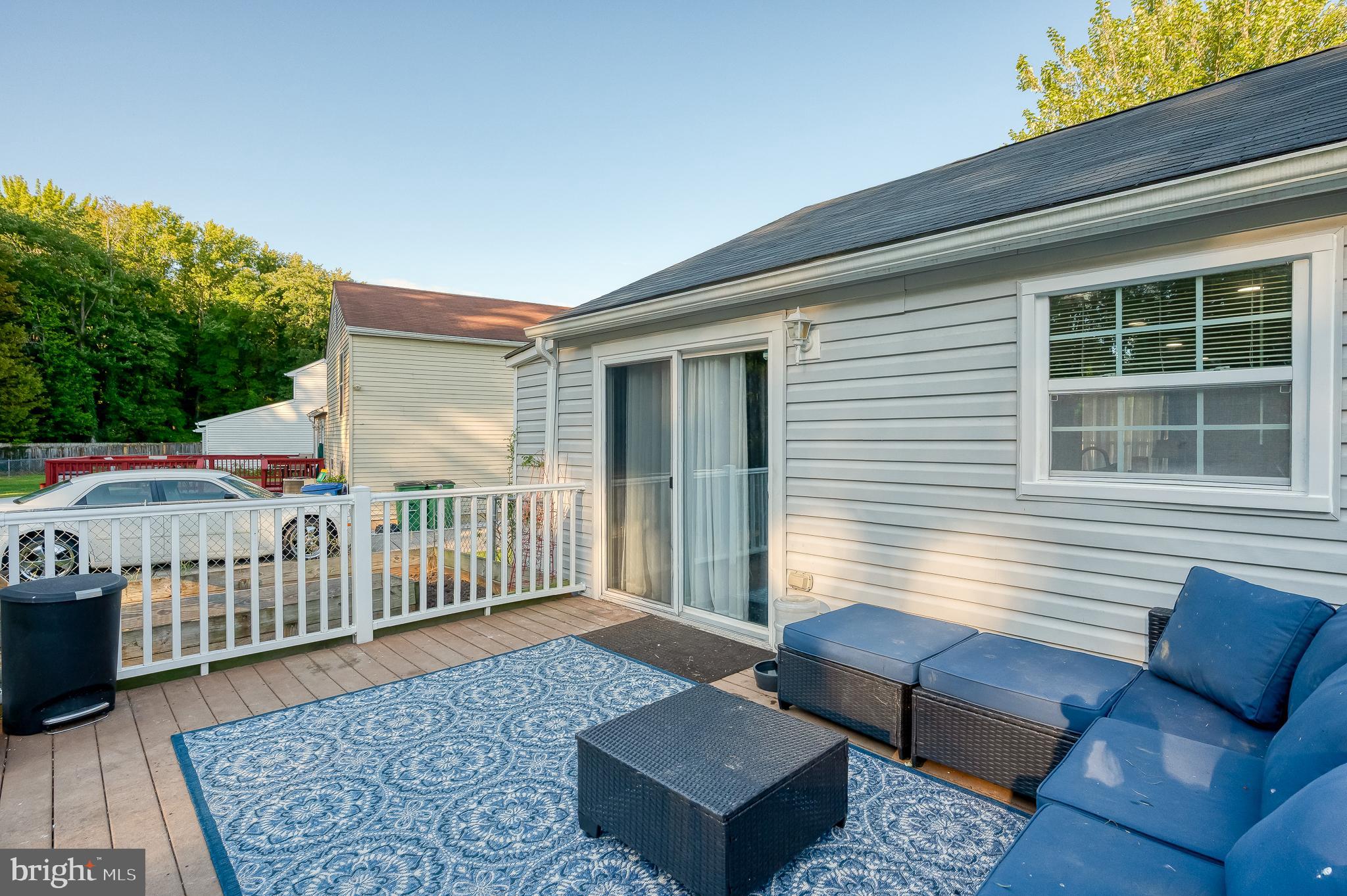 930 Edmund Street Aberdeen, MD 21001 - Photo 6 of 61 a view of a deck with couches floor to ceiling window and wooden floor